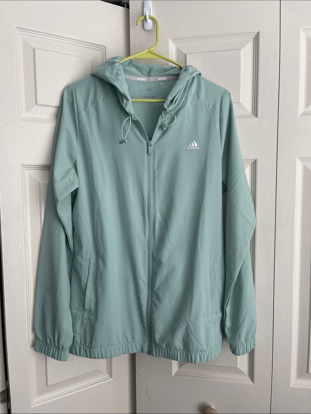 adidas Womens hazy green won wind jacket with hood.  #0358